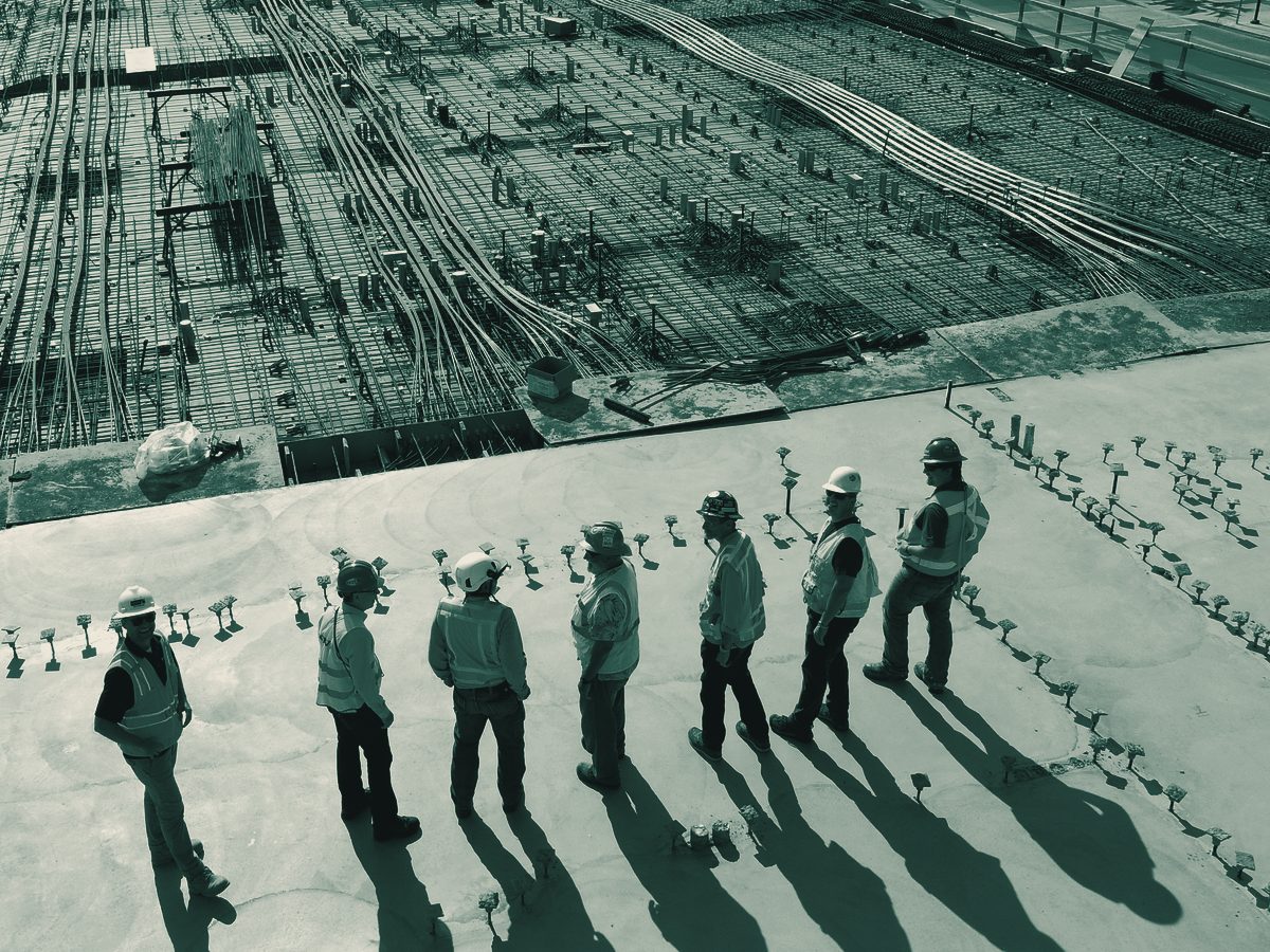 Engineers reviewing a reinforced concrete deck on site